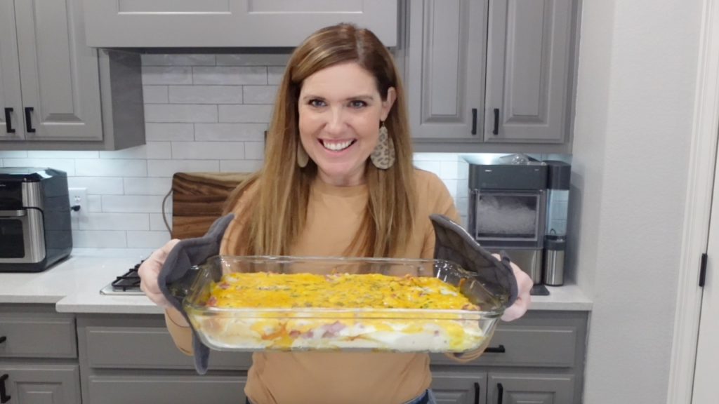 Lindsey holding her finished breakfast squares, straight out of the over