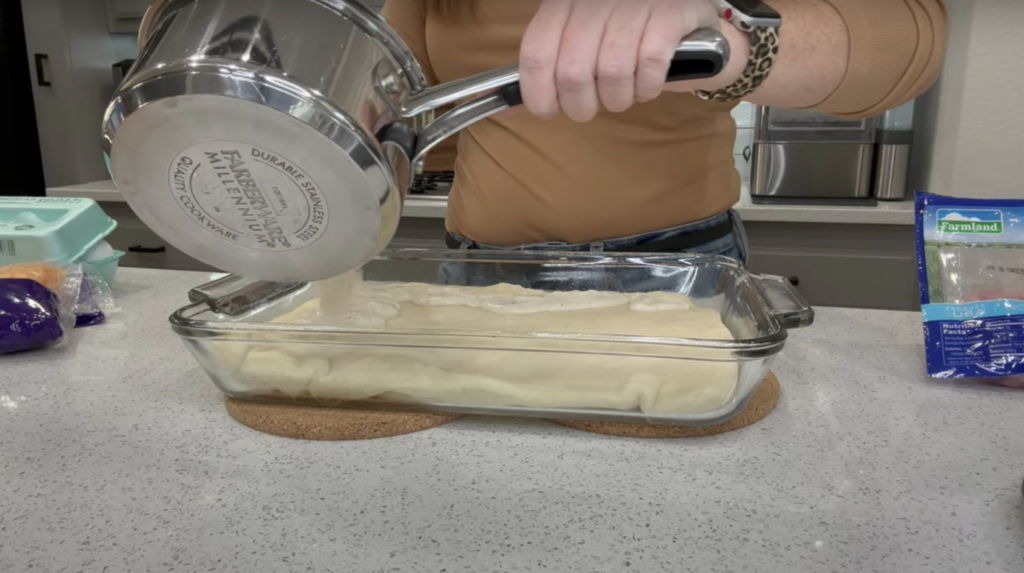 Lindsey pouring pre-made gravy onto her pre-baked pizza crust