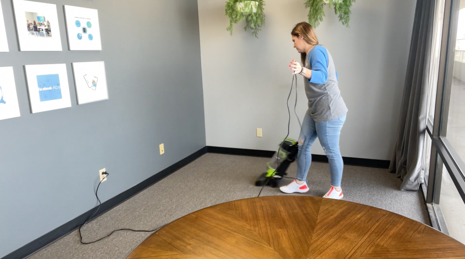 Lindsay vacuuming the office before moving new furniture in