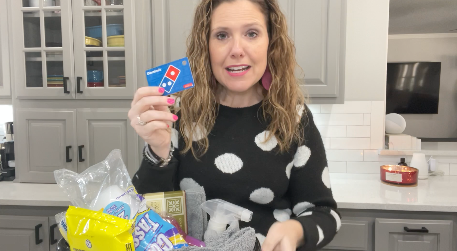 Lindsay holding a Domino's Pizza gift card